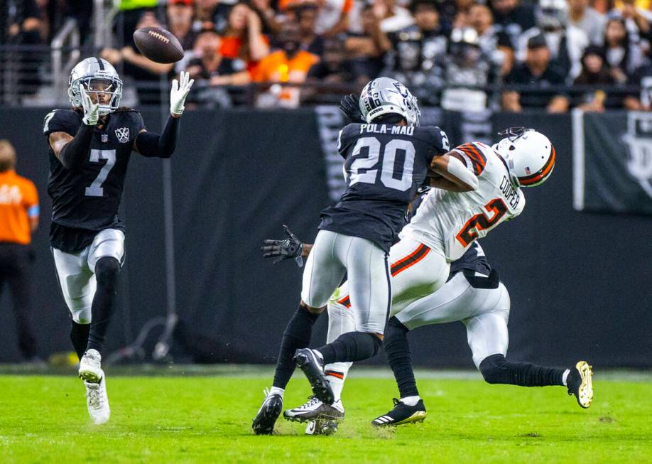 Raiders safety Tre'von Moehrig (7) looks in an interception as safety Isaiah Pola-Mao (20) puts ...