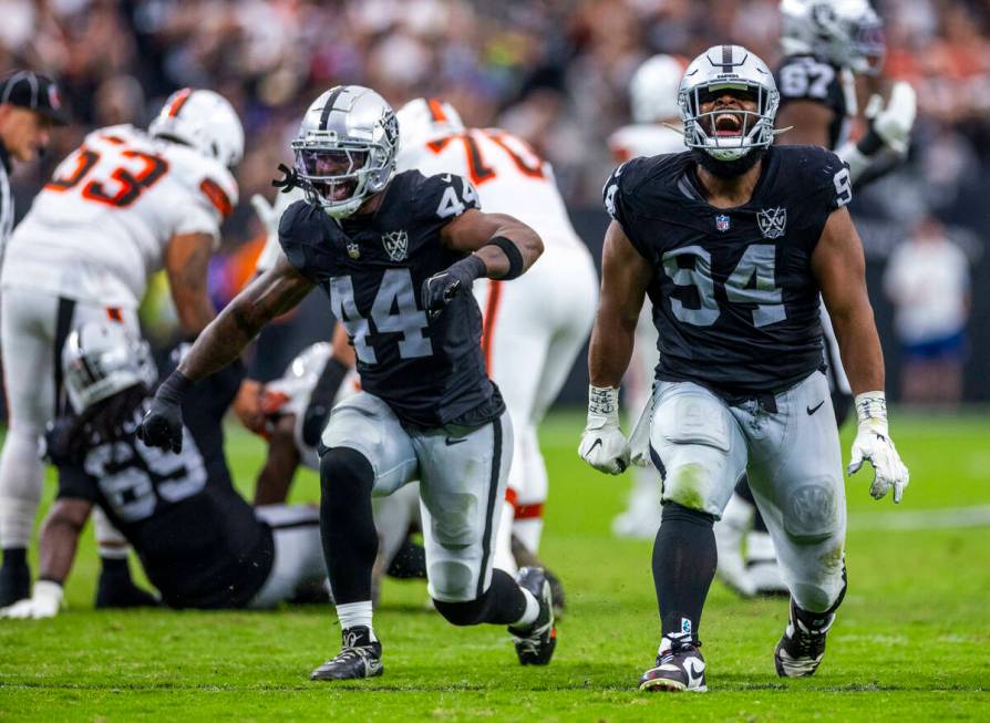 Raiders defensive end K'Lavon Chaisson (44) and defensive tackle Christian Wilkins (94) celebra ...