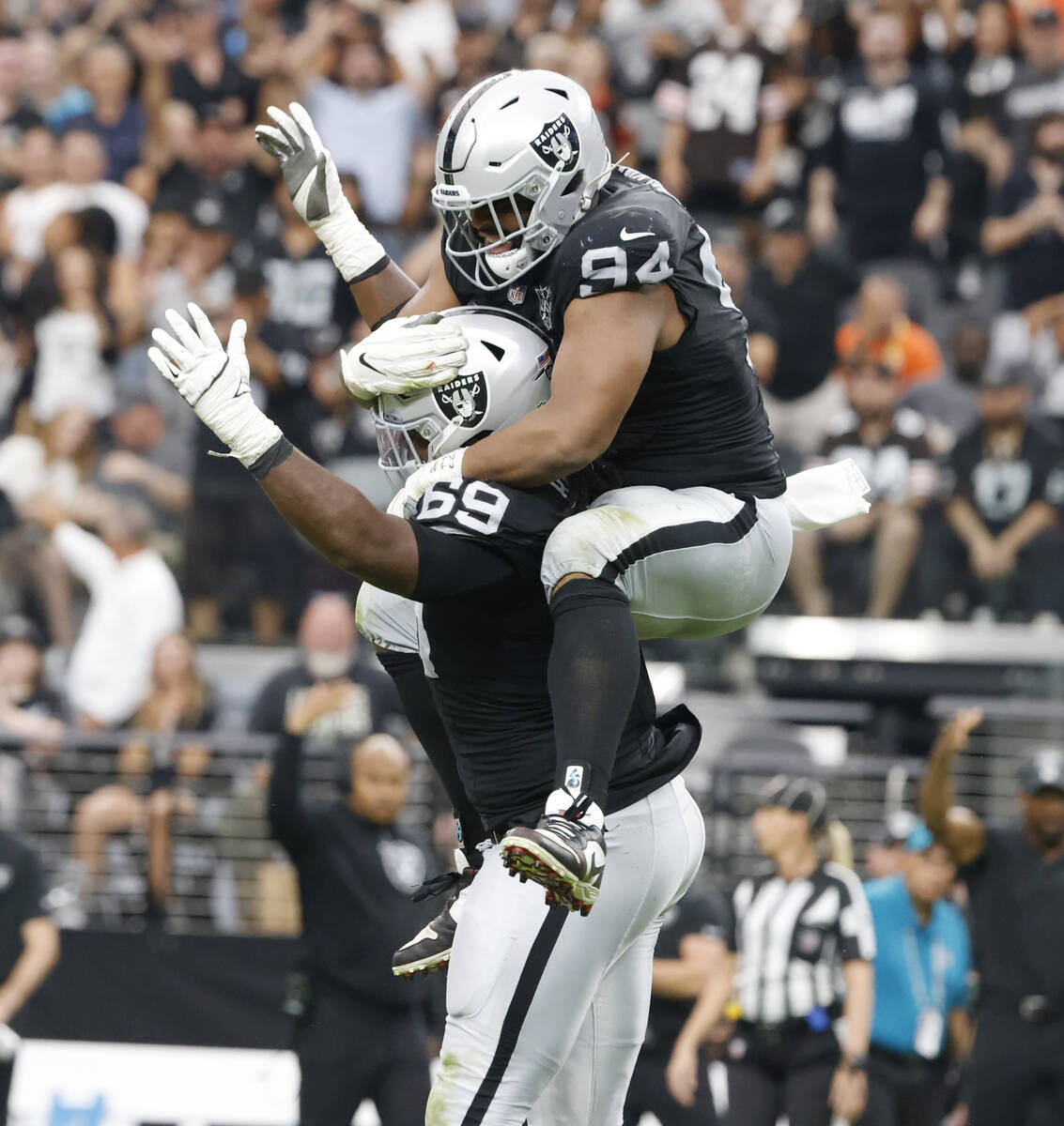 Raiders defensive tackle Adam Butler (69) and defensive tackle Christian Wilkins (94) celebrate ...