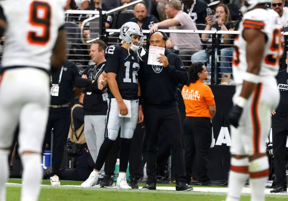 Raiders head coach Antonio Pierce speaks to quarterback Aidan O'Connell (12) on the sidelines d ...