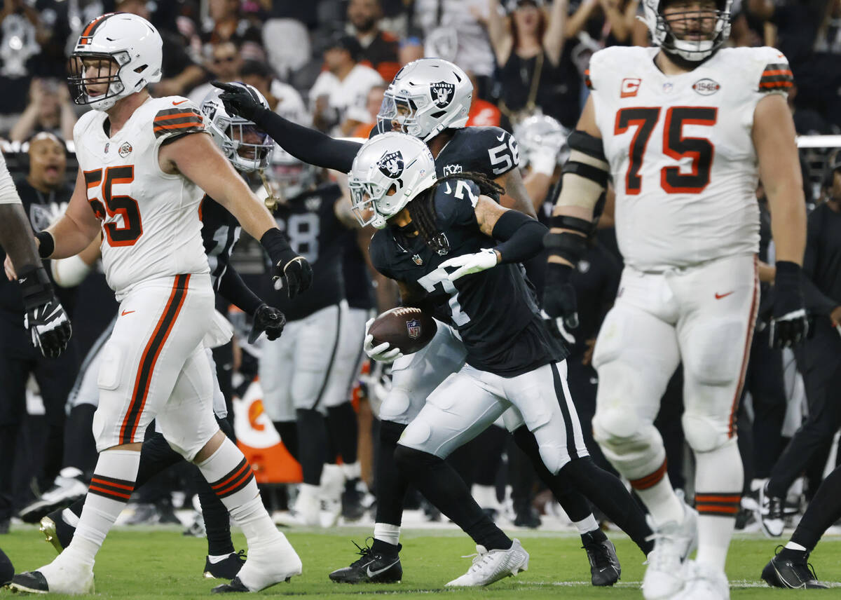 Raiders Tre'von Moehrig (7) reacts with teammate linebacker Amari Burney (56) after interceptin ...