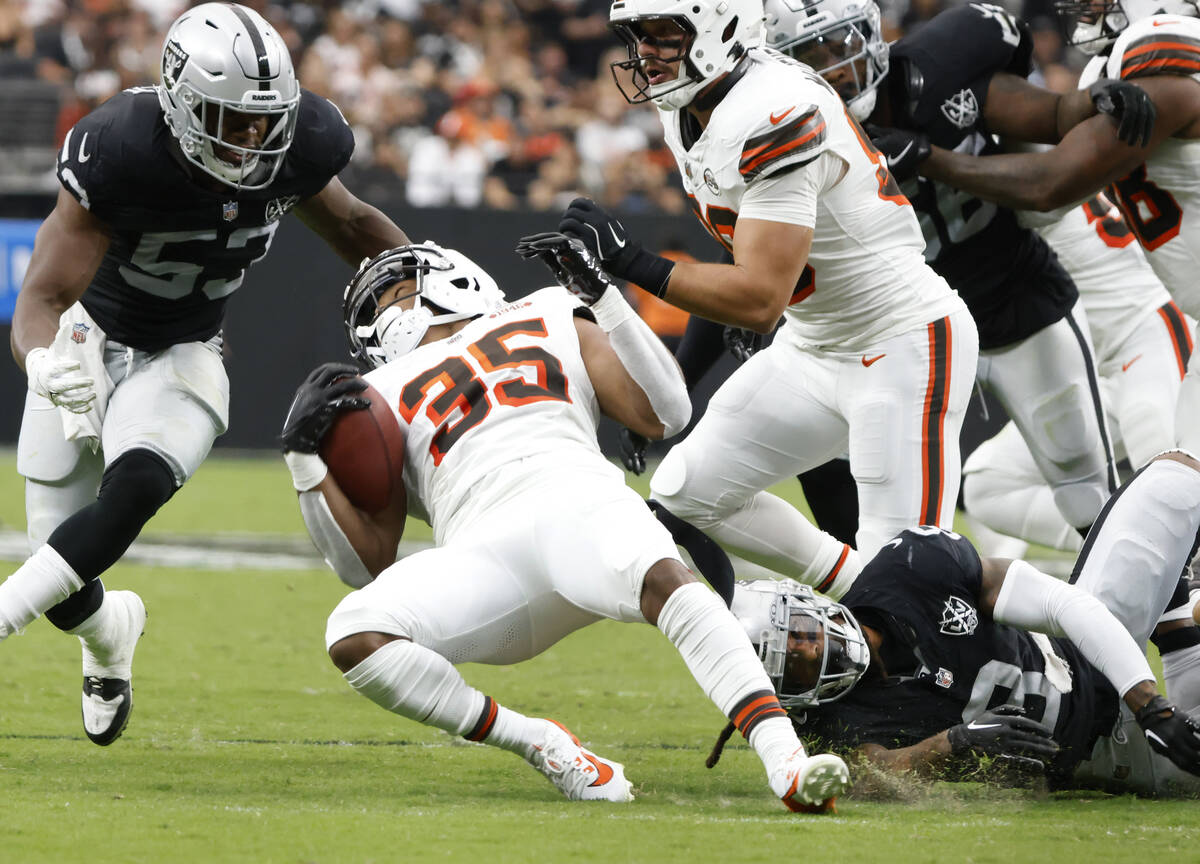 The Cleveland Browns running back Gary Brightwell (35) is tripped by Raiders running back Ameer ...