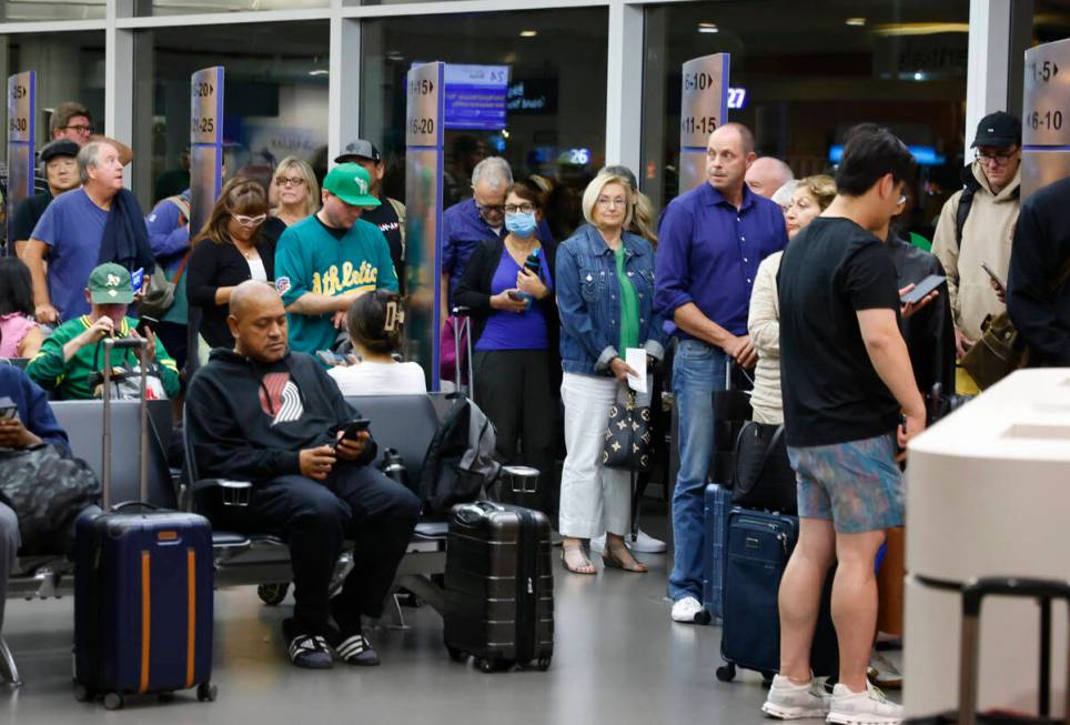 Passengers line up based on boarding group numbers to board a Southwest Airlines flight at Oakl ...