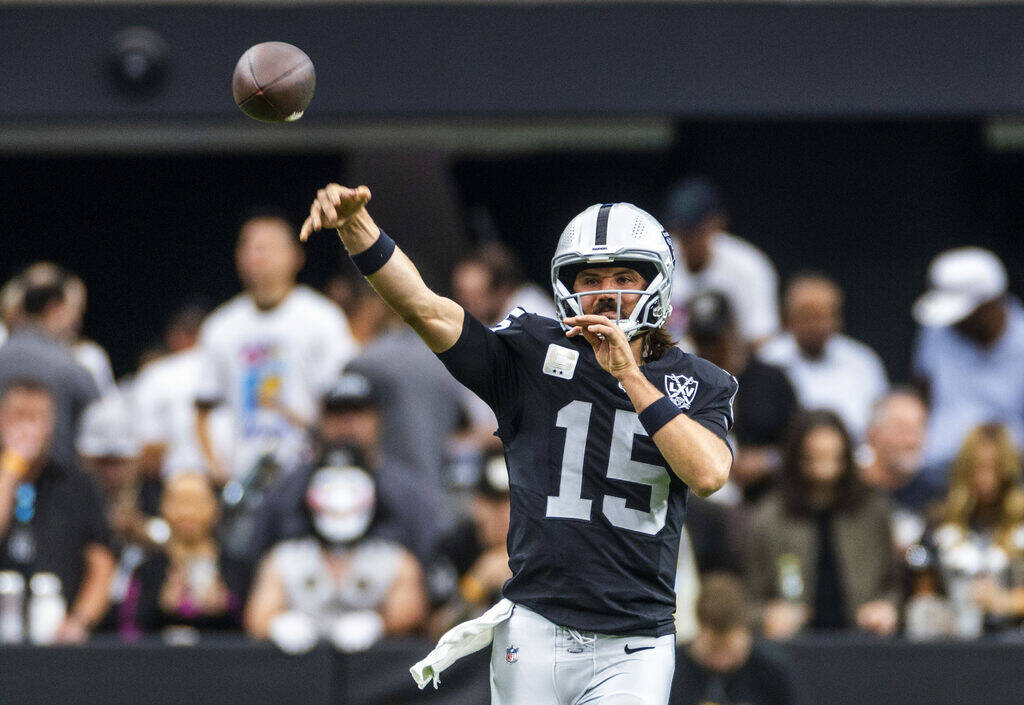 Raiders quarterback Gardner Minshew (15) gets off a pass against the Cleveland Browns during th ...