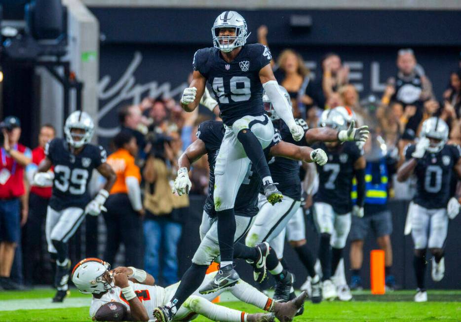 Raiders defensive end Charles Snowden (49) leaps in celebration after a sack of Cleveland Brown ...