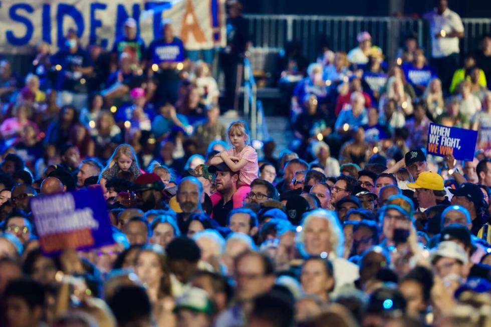 A young child is hoisted up on a pair of shoulders during a campaign event for Democratic presi ...