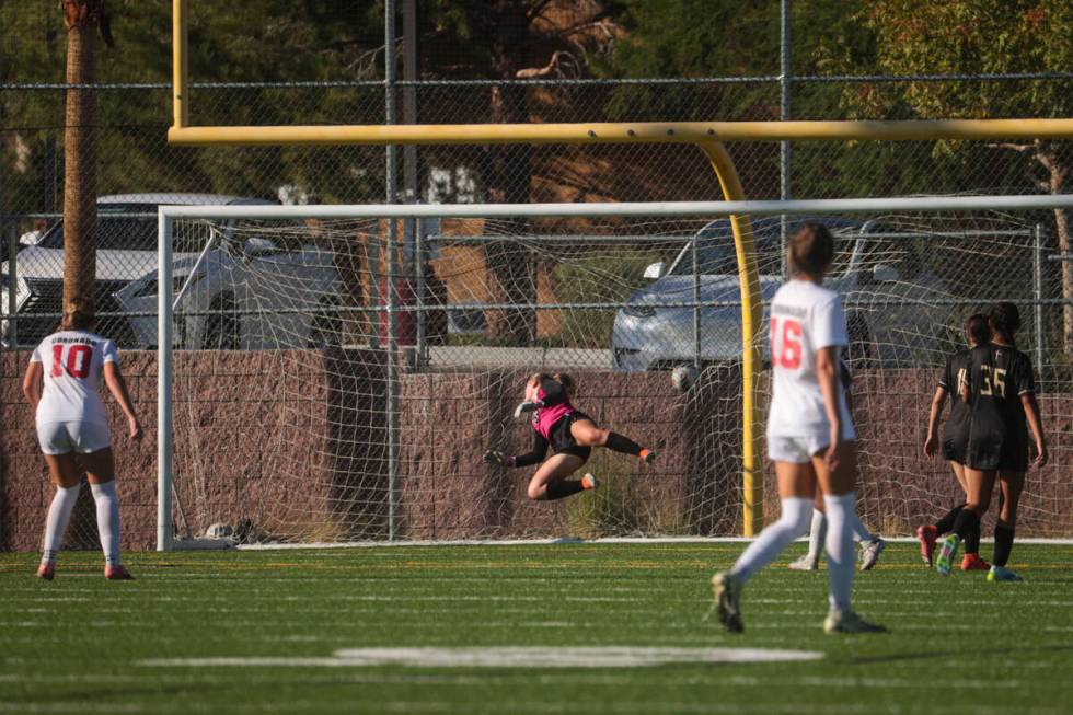 Coronado's Ryan Neel (10) scores a goal against Faith Lutheran goalkeeper Olivia Petty during a ...