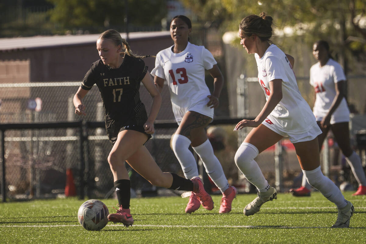 Faith Lutheran's Julia Anfinson (17) brings the ball up the field against Coronado during a soc ...