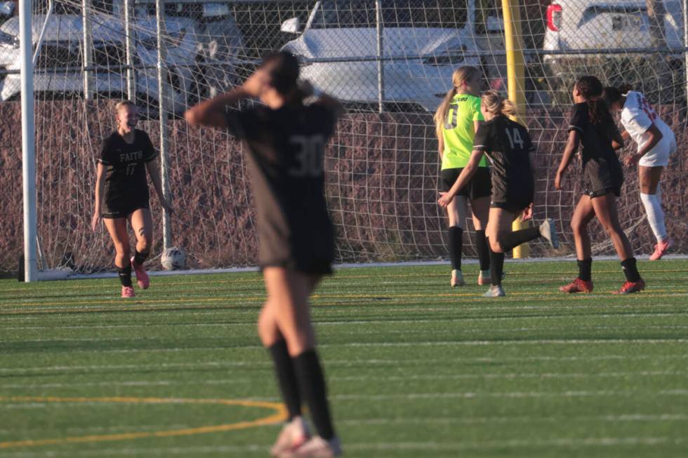 Faith Lutheran players celebrate a goal to tie the game with Coronado during a soccer game at F ...