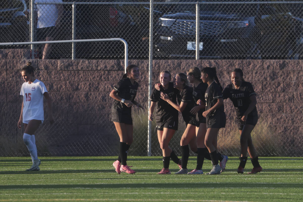 Faith Lutheran players celebrate a goal to tie the game with Coronado during a soccer game at F ...