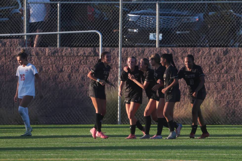 Faith Lutheran players celebrate a goal to tie the game with Coronado during a soccer game at F ...