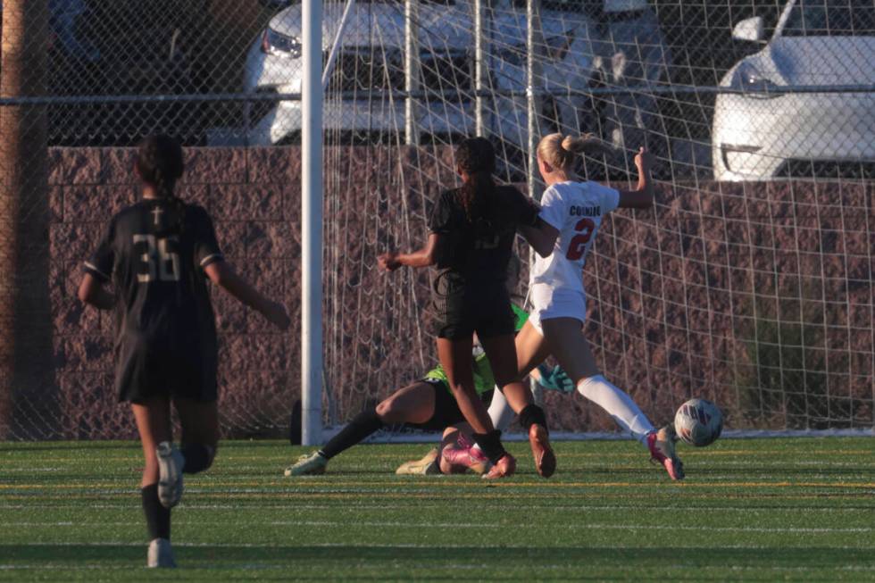 Faith Lutheran's Briana Lee (10) kicks the ball in past Coronado's midfielder Emily McKinney (2 ...