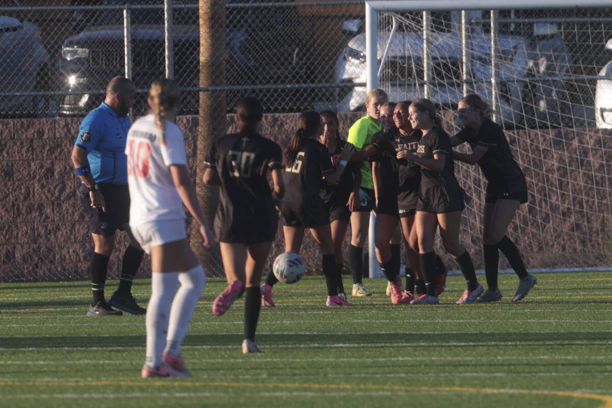 Faith Lutheran's Briana Lee is surrounded by teammates after scoring against Coronado in a socc ...