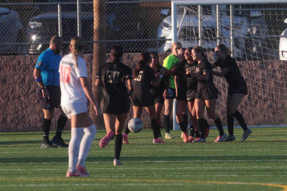 Faith Lutheran's Briana Lee is surrounded by teammates after scoring against Coronado in a socc ...