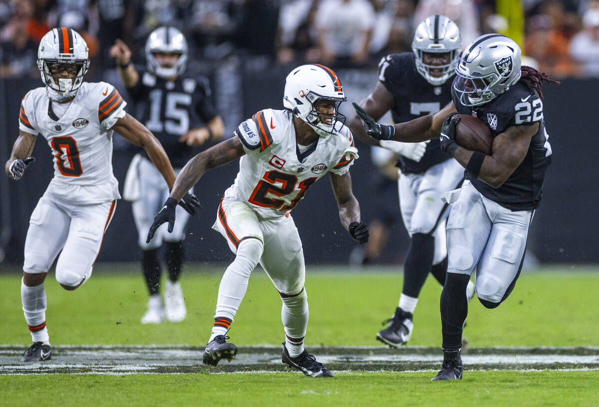 Raiders running back Alexander Mattison (22) takes on Cleveland Browns cornerback Denzel Ward ( ...