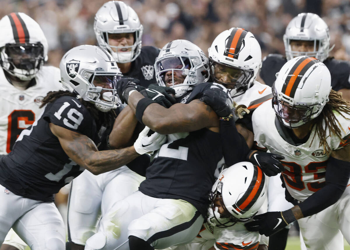 Raiders running back Alexander Mattison (22) protects the ball during the second half of an NFL ...