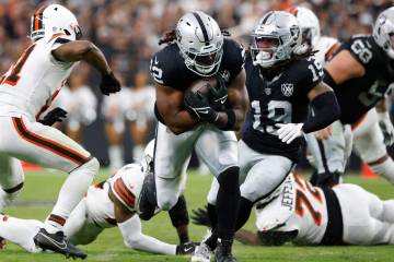 Raiders running back Alexander Mattison (22) runs past Cleveland Browns defense during the seco ...