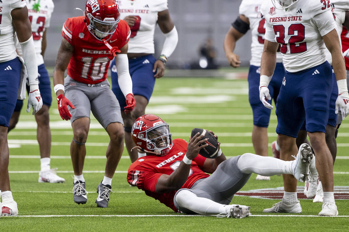 UNLV quarterback Hajj-Malik Williams (6) smiles after making a first down during the college fo ...