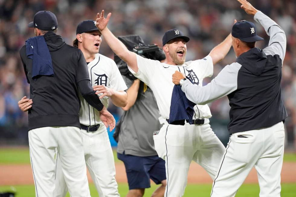 Members of the Detroit Tigers celebrate after the ninth inning of a baseball game against the C ...