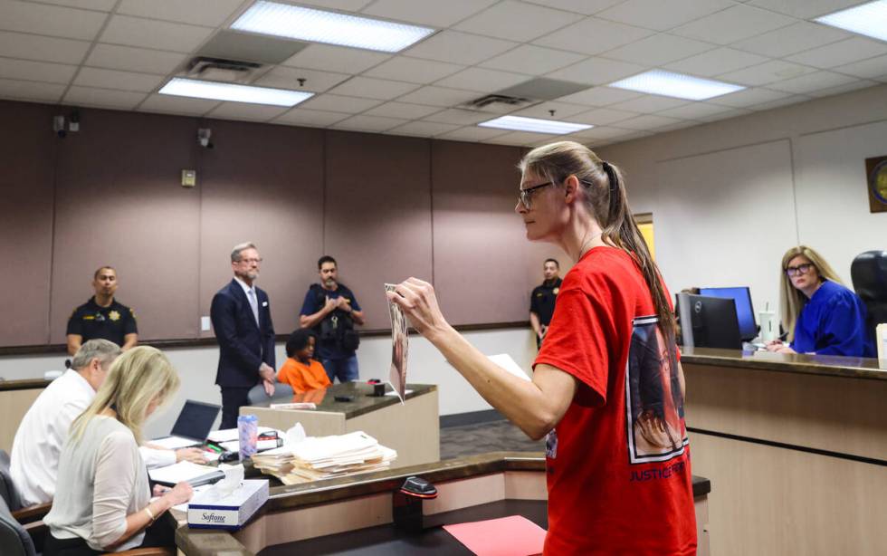 Mellisa Ready holds a photo of her son Jonathan Lewis as she makes a statement to the court dur ...