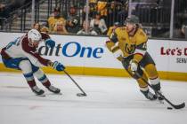 Golden Knights defenseman Noah Hanifin (15) races the puck down the ice during an NHL hockey ga ...