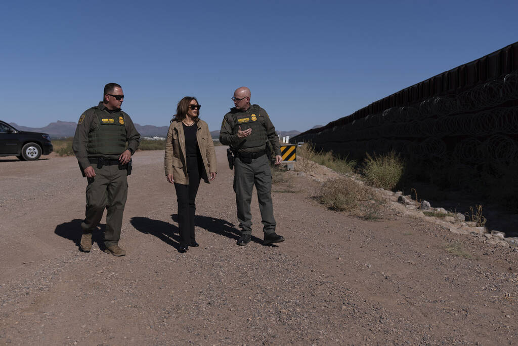 Democratic presidential nominee Vice President Kamala Harris, center, talks with John Modlin, t ...