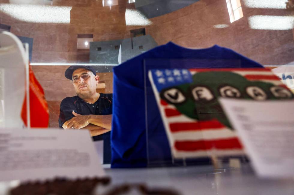 Jose Gomez looks at mementos on display at the “Remembering 1 October” exhibit in ...