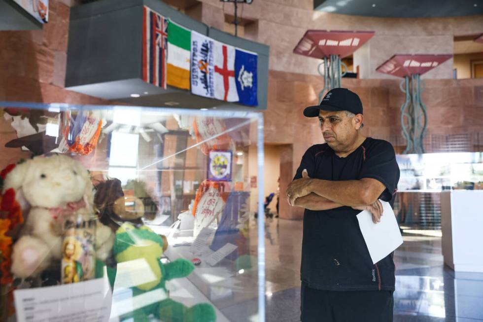 Jose Gomez looks at mementos on display at the “Remembering 1 October” exhibit in ...