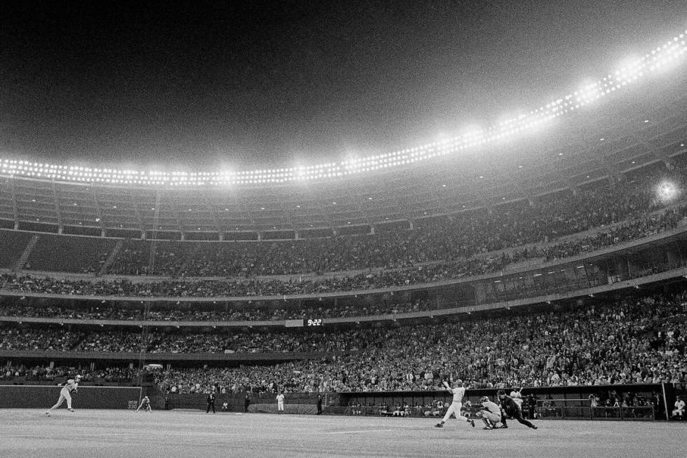 Cincinnati Reds batter Pete Rose drives a single against the Montreal Expos to reach the 3,000 ...