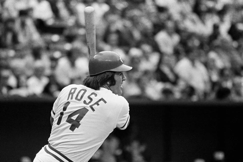 Cincinnati Reds batter Pete Rose watched as he smashes out a hit against the Atlanta Braves on ...