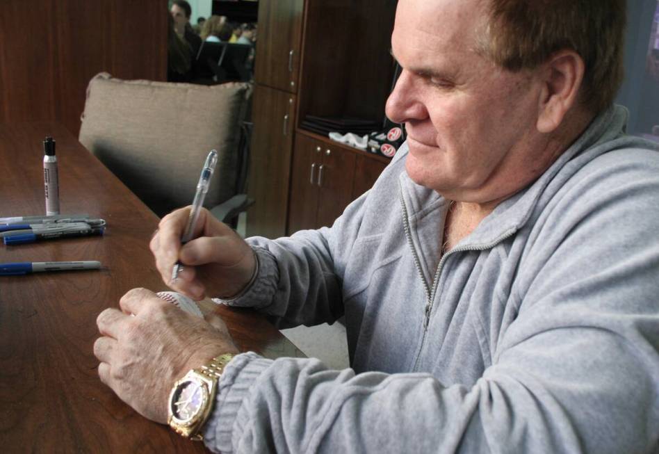 Pete Rose signs a baseballs at Stars Live 365 Monday, Feb. 14, 2005, in Las Vegas. (Las Vegas R ...