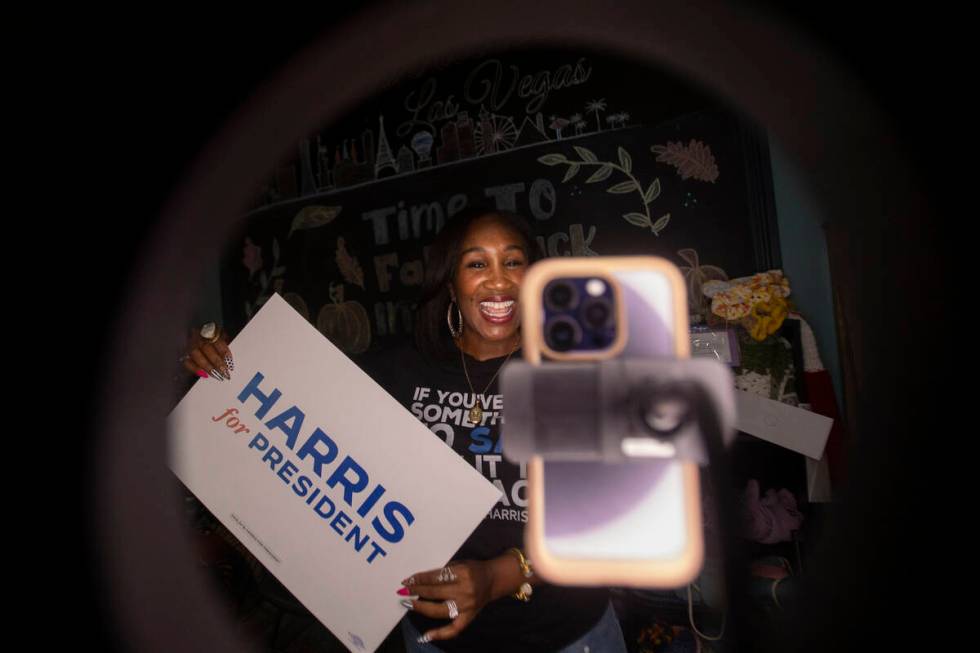 Shaunda Necole records herself during a canvassing and phone banking event for the Democratic p ...