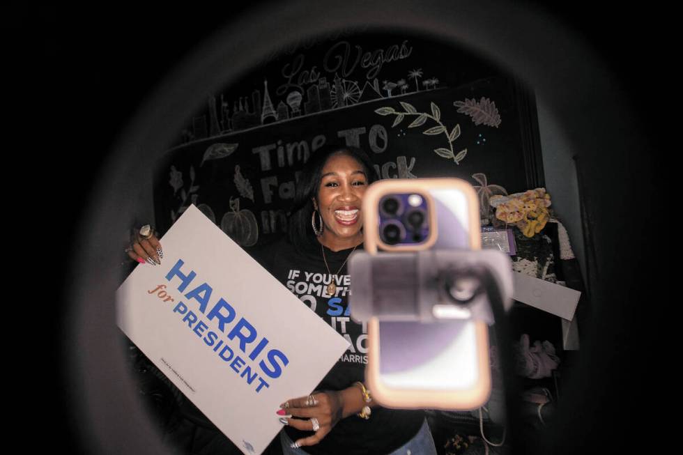 Shaunda Necole records herself during a canvassing and phone banking event for the Democratic p ...