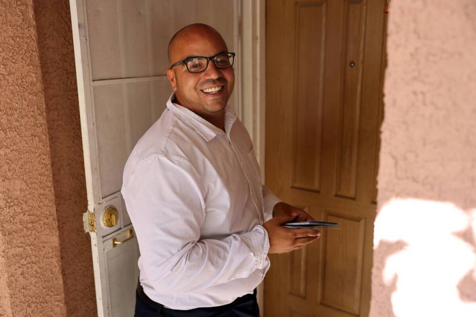 Jovan Jackson, a candidate for Nevada Assembly District 6, knocks on a door while canvassing in ...