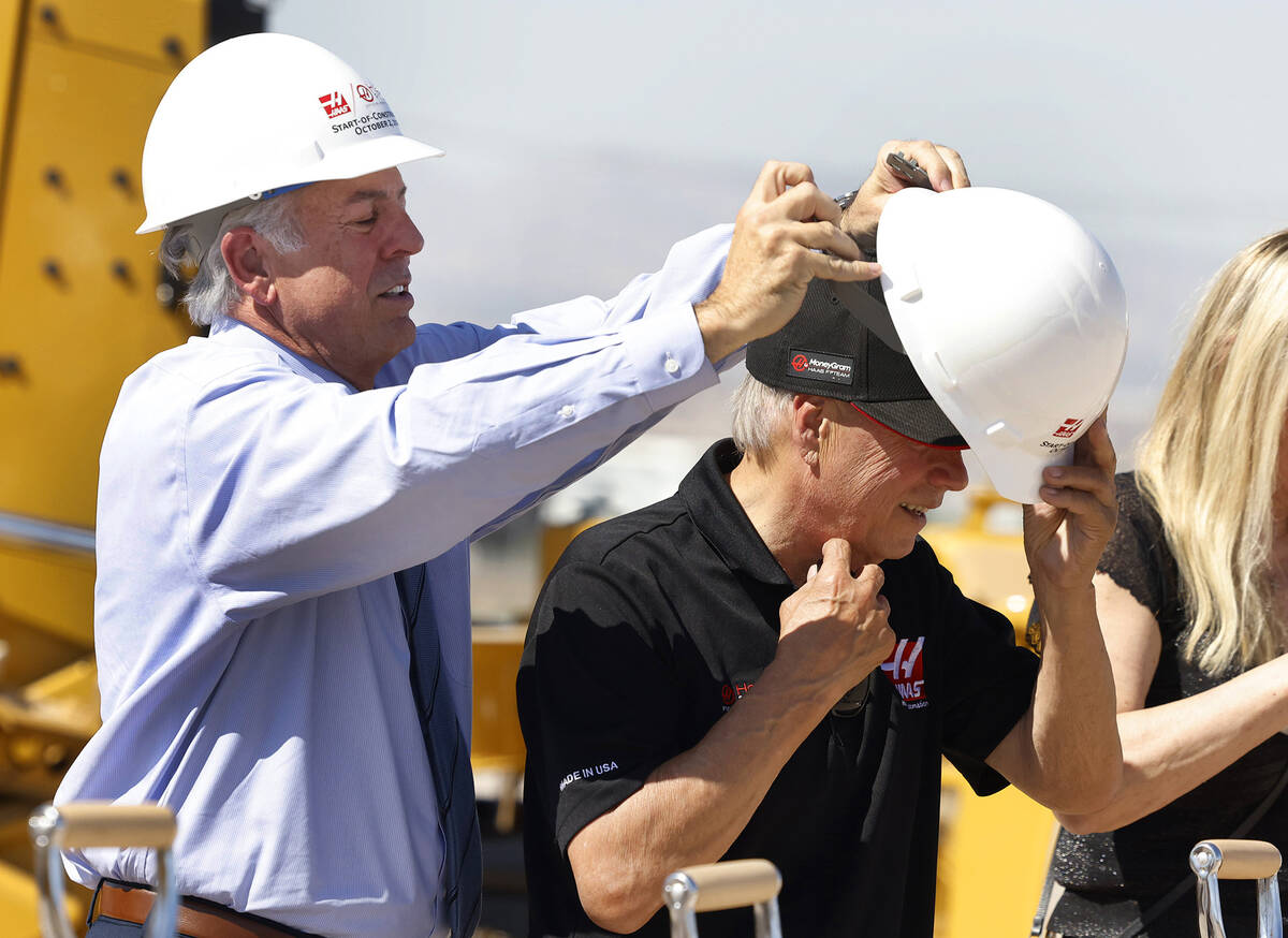 Gene Haas, right, Haas founder and CEO, gets help from Gov. Joe Lombardo as he tries to put his ...