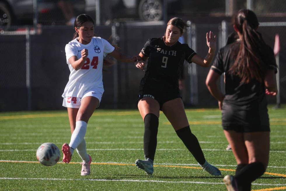 Coronado's Asia Moises (24) kicks the ball under pressure from Faith Lutheran's Leila Armstrong ...