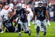 Raiders defensive end K'Lavon Chaisson (44) and defensive tackle Christian Wilkins (94) celebra ...