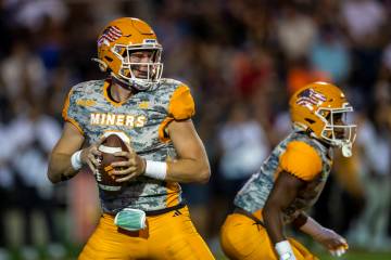 UTEP quarterback Gavin Hardison, left, looks to throw a pass during the first half of an NCAA c ...