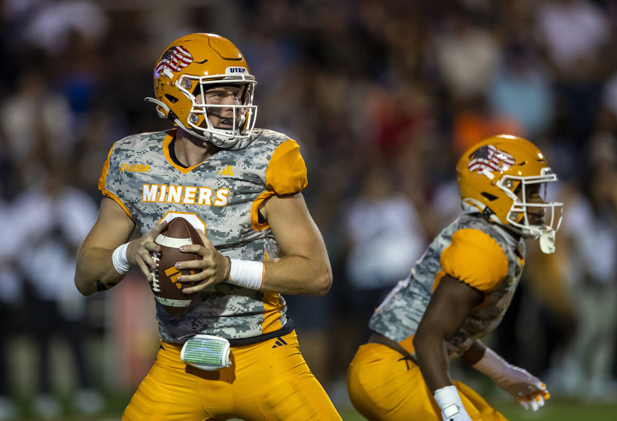 UTEP quarterback Gavin Hardison, left, looks to throw a pass during the first half of an NCAA c ...