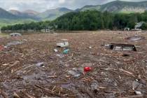 Flood debris from Hurricane Helene floats by in Rutherford County, N.C., Sunday, Sept. 29, 2024 ...