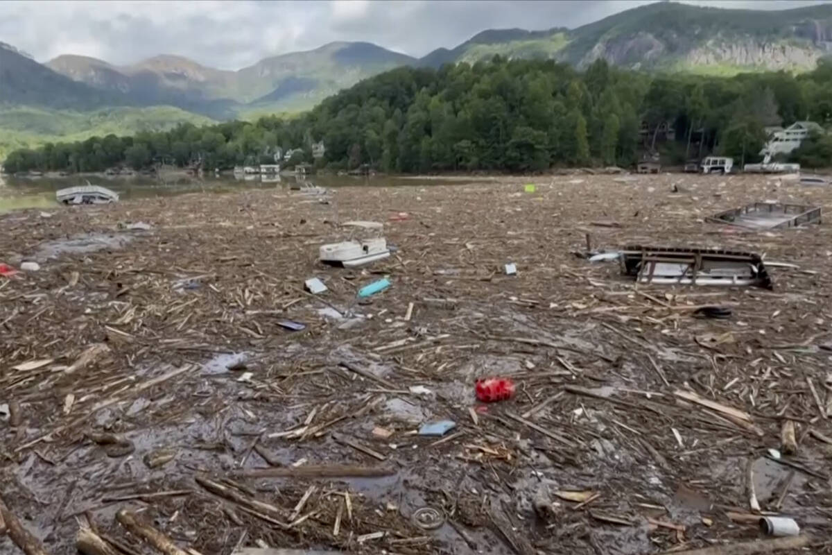 Flood debris from Hurricane Helene floats by in Rutherford County, N.C., Sunday, Sept. 29, 2024 ...