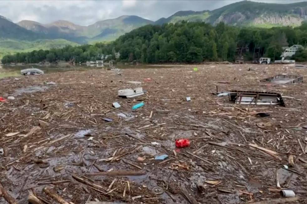 Flood debris from Hurricane Helene floats by in Rutherford County, N.C., Sunday, Sept. 29, 2024 ...