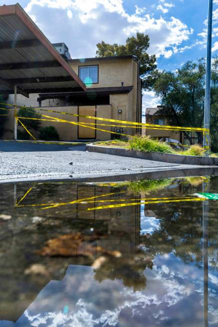 Caution tape is wrapped about a carport area as water continues to pool along Natalee Drive whe ...