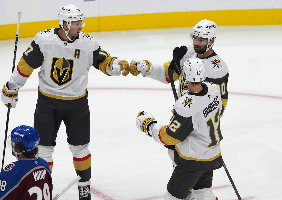 Vegas Golden Knights center Zach Aston-Reese, back right, is congratulated after scoring a goal ...