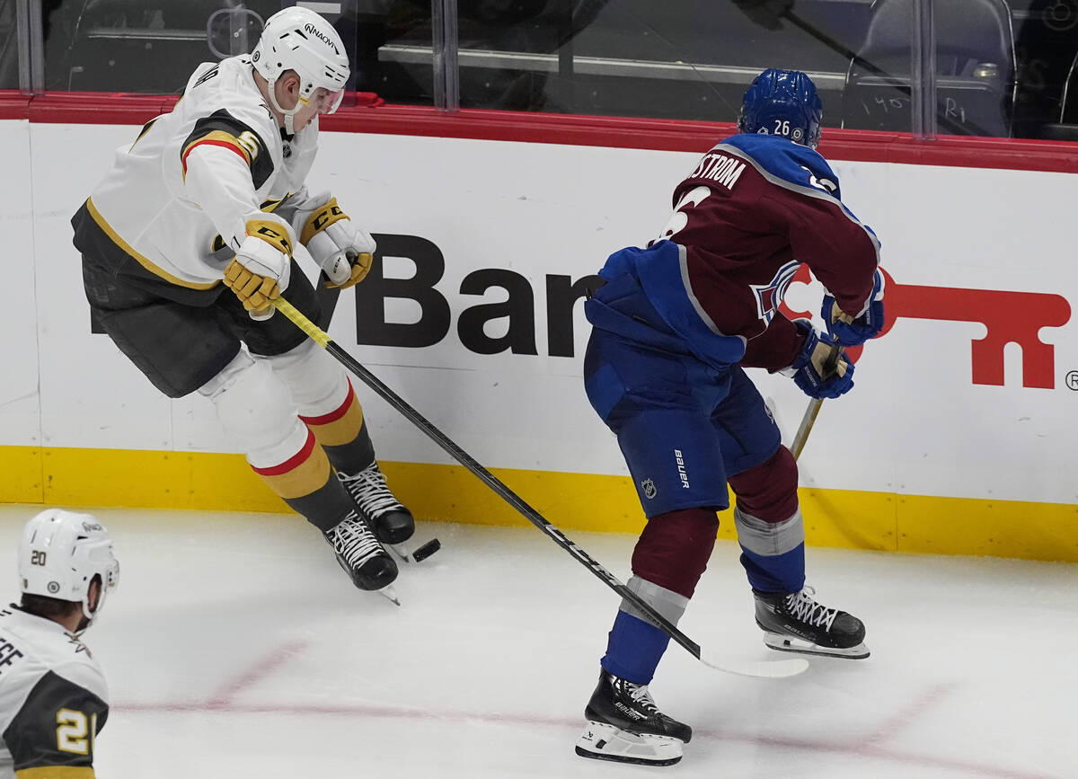 Vegas Golden Knights defenseman Daniil Chayka, left, blocks a pass by Colorado Avalanche defens ...