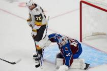 Vegas Golden Knights winger Tanner Pearson, left, redirects the puck past Colorado Avalanche go ...