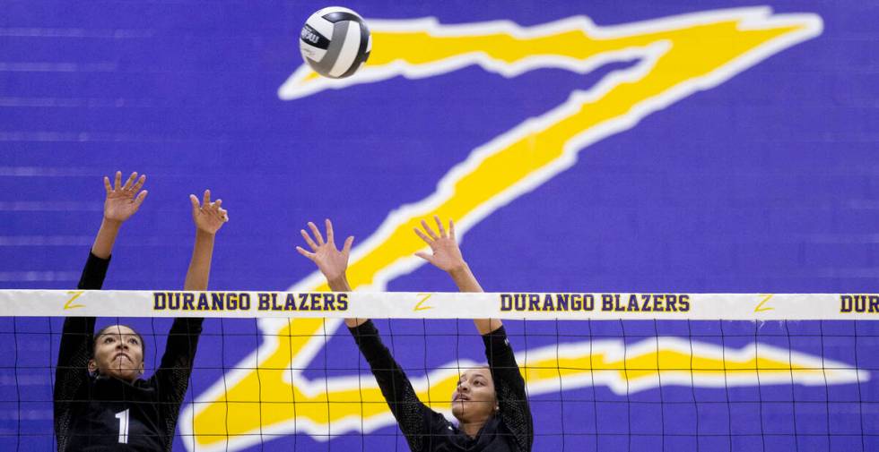 Durango sophomore Taylor Anderson, left, and Durango senior Alana Riddick, right, attempt to bl ...