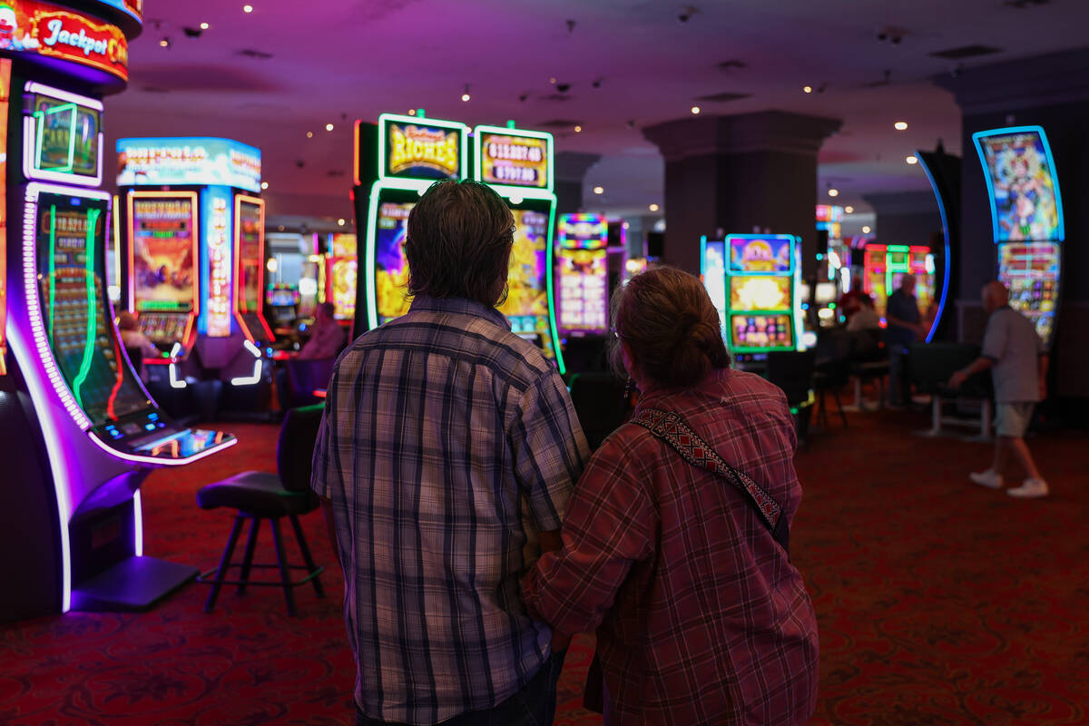 A couple looks on to the casino floor at Edgewater casino-resort on Tuesday, Sept. 17, 2024, in ...