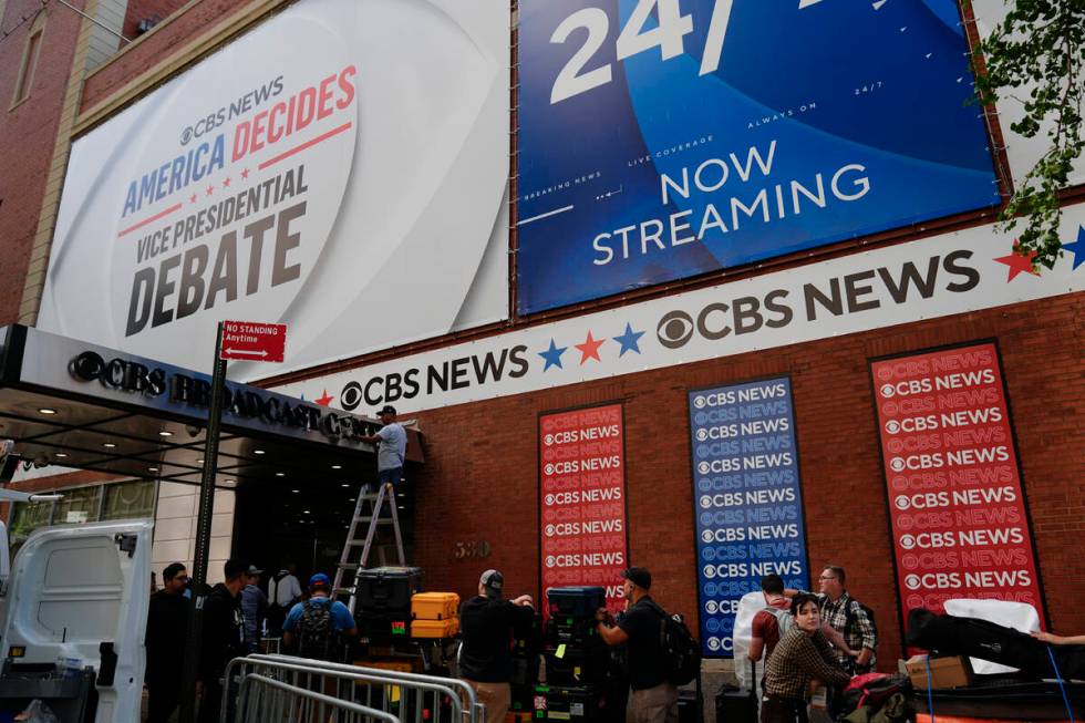 Members of the press wait to bring in equipment a day ahead of a CBS News vice presidential deb ...