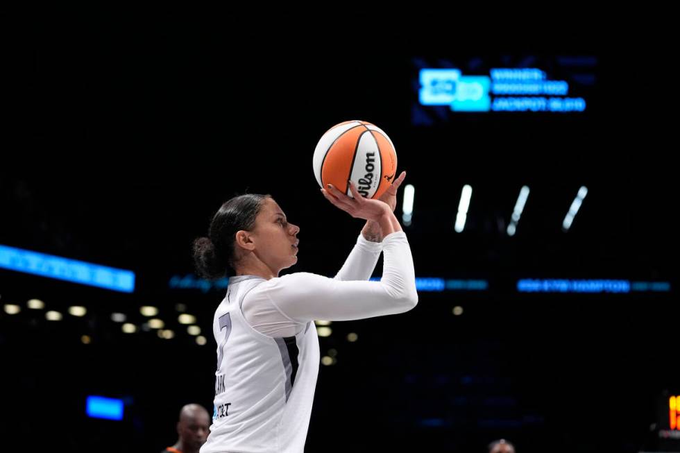 Las Vegas Aces' Alysha Clark (7) shoots a three-point shot during the second half of a WNBA bas ...